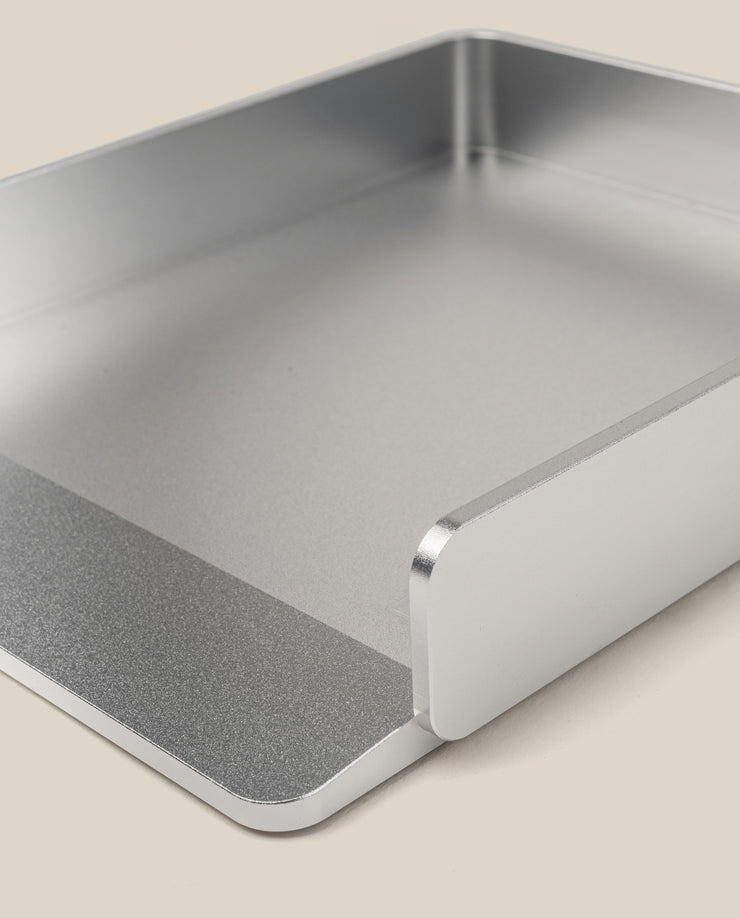 A close-up of the Analog Capture Kit - Small & Large (Silver Aluminum), a rectangular tray with raised sides and open front, ideal for organizing Dot Grid Cards, shown on a light beige surface.