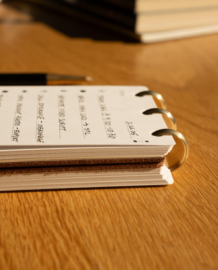 Open notebook with handwritten notes on a wooden surface