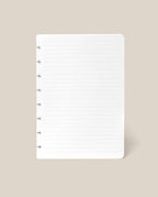 A single sheet from the Discbound Journal Refill - Lined (Standard 6″ x 8.5″), featuring white, lined paper with punched holes on the left side, displayed on a beige background—ideal for replenishing your Heirloom Discbound Journal.