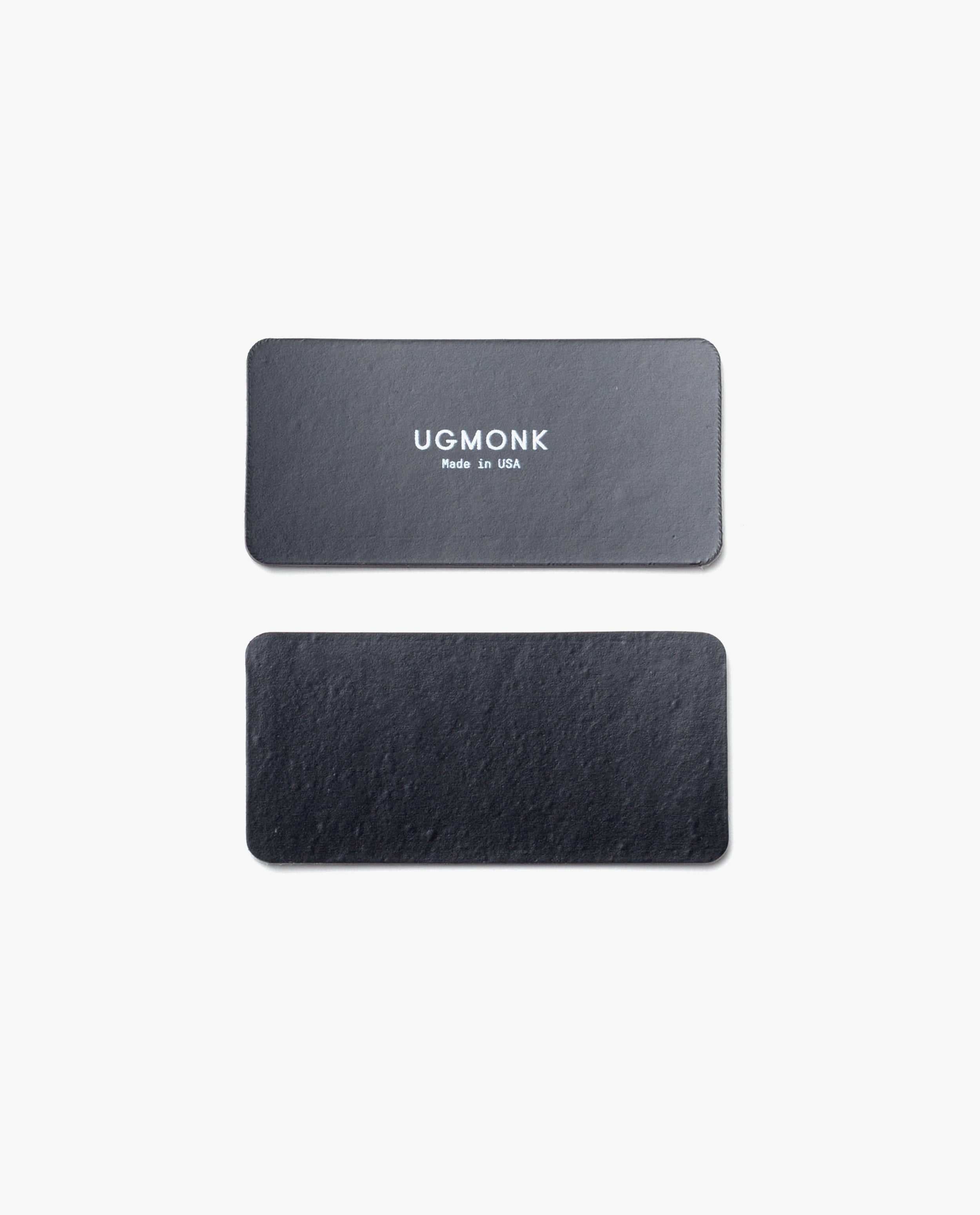 Two black rectangular leather tags for the Magnet Kit (For Analog Card Holder) are shown on a white background. The top tag displays "UGMONK Made in USA" in white, while the bottom tag is plain with no text or markings.