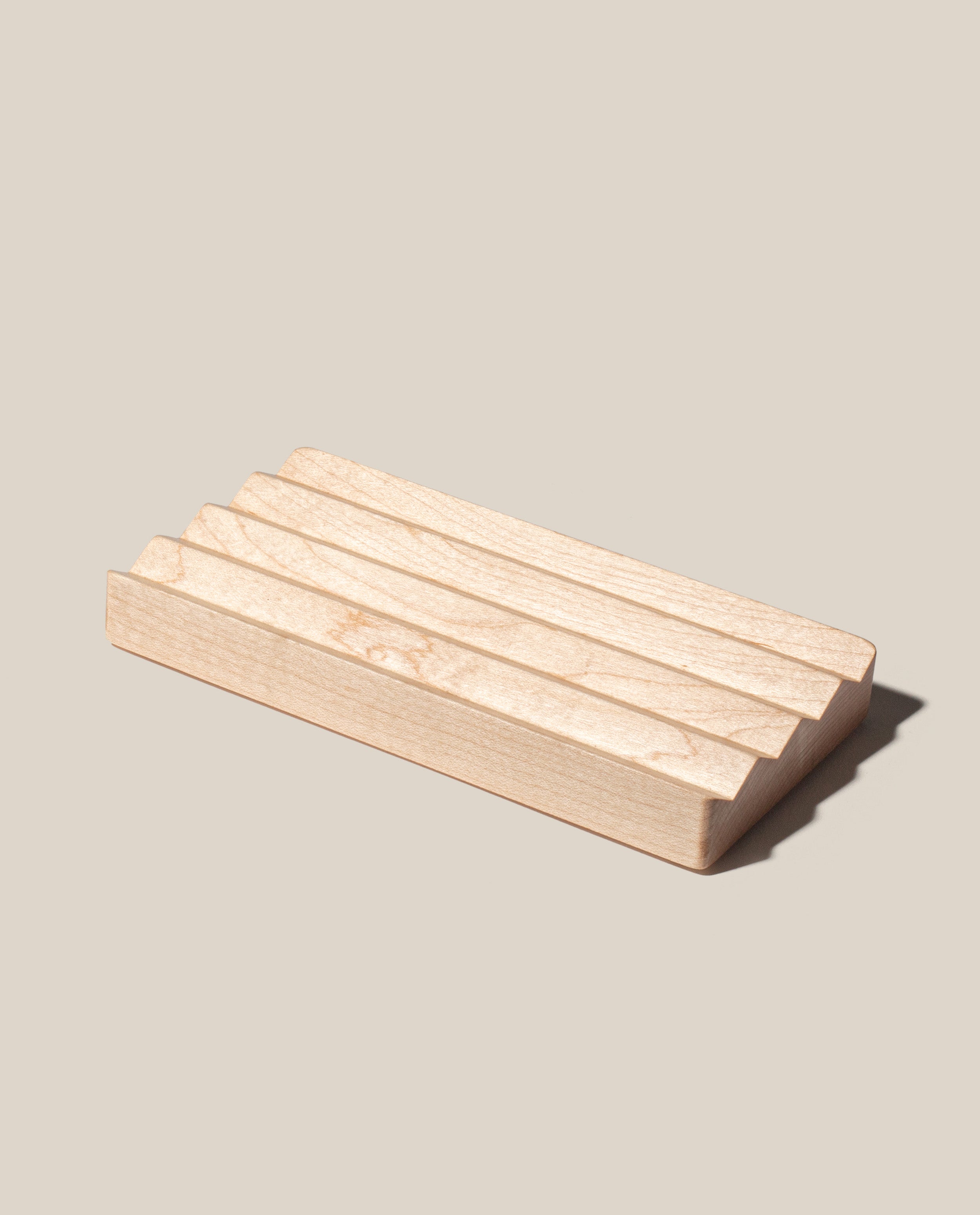 The Gather Wood Zigzag Tray (2x1 - Maple) is a rectangular tray made from solid maple, with parallel shallow grooves across its surface, shown on a light beige background.