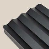 The Complete Analog Collection (Black Aluminum) features a sleek, minimalist tray with four angled grooves and rounded edges, photographed on a light beige background—a modern geometric desktop organizer.