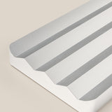 A close-up of the Analog Multi Pen Tray (Silver Aluminum), a sleek rectangular pen holder with three angled grooves, white sides, and rounded corners, displayed on a beige background.