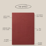 A Layflat Notebook (Maroon) is centered on a beige background, featuring Smyth sewn binding, embossed card stock covers, 160 pages of 70lb smooth white paper, 5mm dot grid, rounded corners, and a 6x8.5" size.