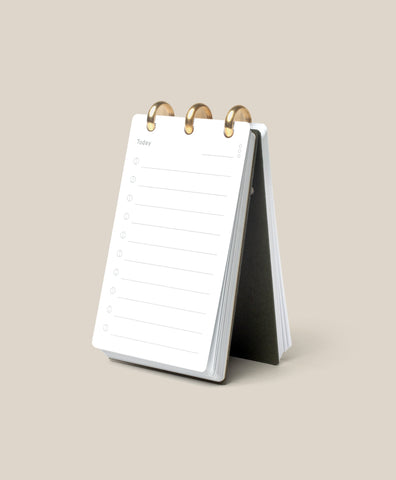 The Discbound Analog, a compact white refillable task organizer, rests open on a beige surface to a fresh “Today” page—ideal for anyone who enjoys working with an analog productivity system.