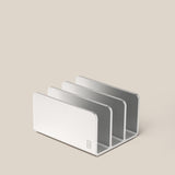 The Analog Card Organizer (Silver Aluminum) features three minimalist slots, ideal for storing cards or organizing mail, files, and devices. Shown on a plain beige surface.