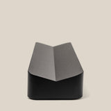 The Analog Pen Tray (Black Aluminum) features a sleek, angular design with a central crease, ideal as a modern desk organizer. Shown on a plain, light beige background, its minimalist style complements any workspace.