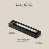 The Analog Pen Tray (Black Aluminum) is a sleek, minimalist desk organizer made from solid anodized aluminum with non-slip silicone pads and a V-shaped cradle. Dimensions: 5.77 x 1.33 x .62 inches—perfect for holding your pen in style.