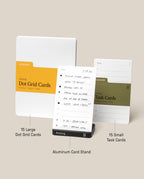 The Analog Starter Kit (Black) includes a pack of 15 large Dot Grid Cards, a pack of 15 small Task Cards—perfect for building your analog paper card workflow—and an Aluminum Card Stand displaying a handwritten task list on a card. Each item in the kit is clearly labeled with its name and description.