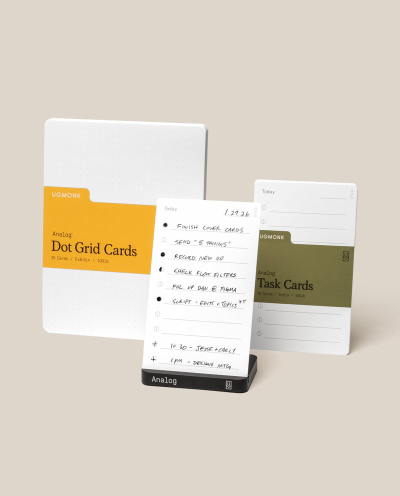 Three sets of cards from the Analog Starter Kit (Black)—Dot Grid, a handwritten Today card, and Task Cards—are displayed on a sleek aluminum card stand against a light beige background, showcasing the elegance and utility of this paper card system.