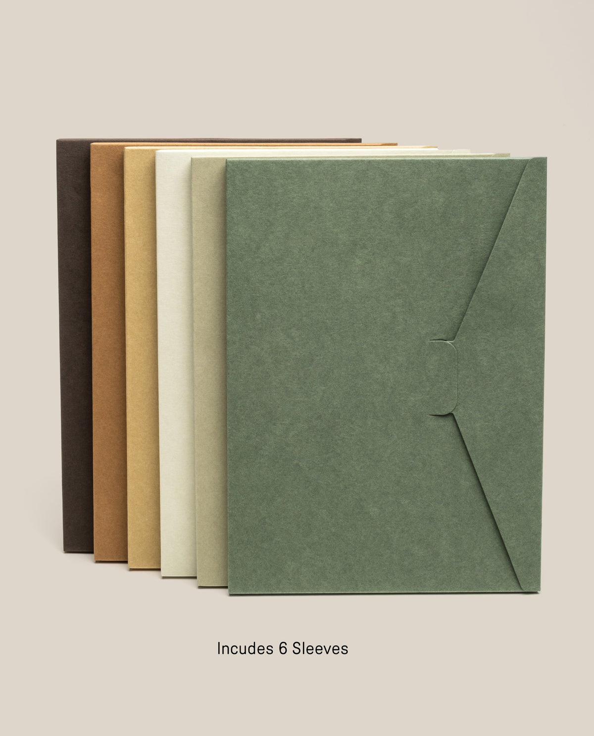 Six Discbound Journal Archive sleeves in assorted earthy tones are arranged upright in a row against a beige background. Ideal for storing refillable journal pages or organizing your Discbound Journal system, these stylish and practical sleeves offer versatile storage solutions. Text below reads, Includes 6 Sleeves.
