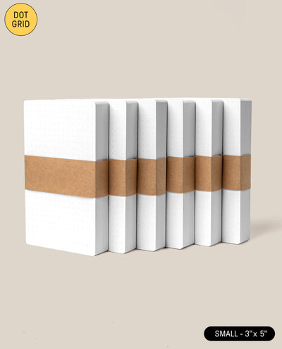Six Analog Dot Grid Cards - Small (3x5, 6-Pack) with white covers are stacked upright and secured by a brown band. Labels "DOT GRID" and "SMALL - 3x5" appear on a beige background. Great for dot grid card or note card fans.
