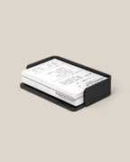The Complete Analog Collection (Black Aluminum): a black metal organizer holding white index cards with handwritten notes, displayed on a neutral beige background.