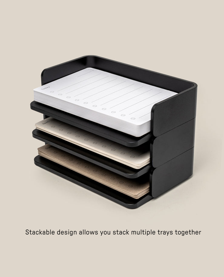 The Analog Capture Kit - Small (Black Aluminum) features stackable trays holding colorful notepads and Small Dot Grid Cards, showing how multiple trays can be organized together. Text below: Stackable design lets you stack several trays as needed.
