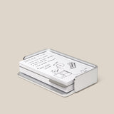 The Analog Capture Kit - Small (Silver Aluminum) features white dot grid cards with black handwritten notes and drawings, neatly arranged in a sleek silver aluminum tray on a plain beige background.