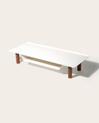 The Gather Small Monitor Stand (White/Walnut) features a modern raised platform, walnut cylindrical legs, and a lower storage slot, providing a sleek, space-saving desk organizer ideal for minimalist setups.