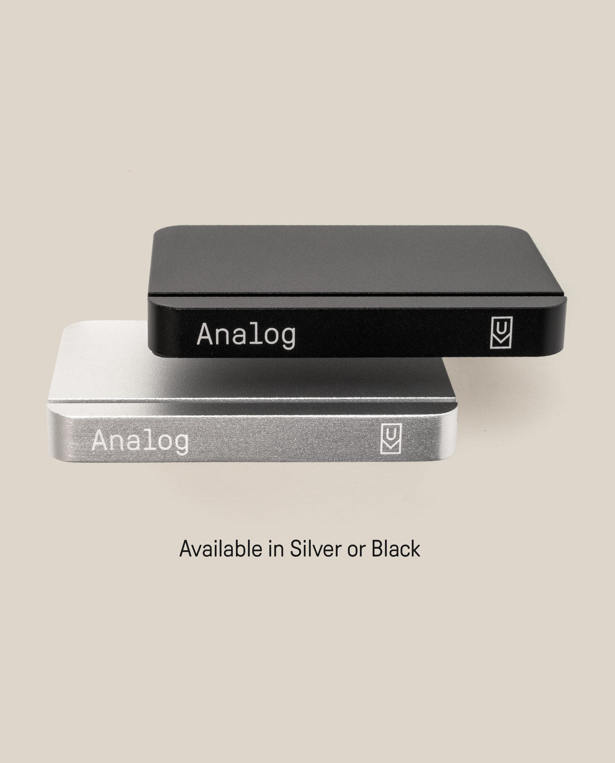 Two rectangular metal cases, one black and one silver, each labeled “Analog” with a small logo. The Analog Starter Kit (Silver) is designed as an elegant aluminum card stand for task cards or any paper card system. Text below reads: Available in Silver or Black.