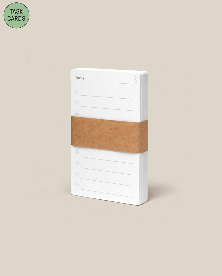 The Analog - Task Cards (1-Pack) features a stack of white cards labeled "Today" with checkboxes, bound by a brown paper band on a beige background. A green circle at the top left says "TASK CARDS—perfect for task prioritization.