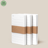 Three stacks of Analog - Task Cards (3-Pack), each wrapped in a brown paper band, sit side by side on a beige background. A green circle in the top left corner displays “TASK CARDS”—ideal for your analog productivity system.