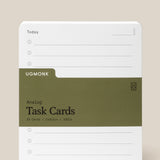 A stack of Analog Task Cards - Large made from uncoated cardstock, held by an olive green band, features checkboxes and lines for jotting tasks or ideas. The visible card is labeled “Today” and rests on a neutral background.