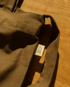 Close-up of a Utility Tote Bundle - Set of 3 durable heavyweight cotton canvas tote bag with a small rectangular tag featuring a geometric logo.
