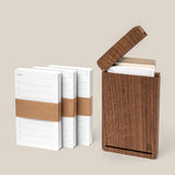 The Analog Travel Case + 3 Card Packs (Walnut) includes a premium walnut wood case with a hinged lid and three extra card packs, perfect for organizing your cards at home or on the go.