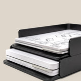 A black Analog Capture Kit - 2 Large (Black Aluminum) holds two notebook stacks and a sleek card tray with dot grid cards—perfect for organizing sketches and notes. One stack is on the top shelf; the other is below, set against a plain beige background.