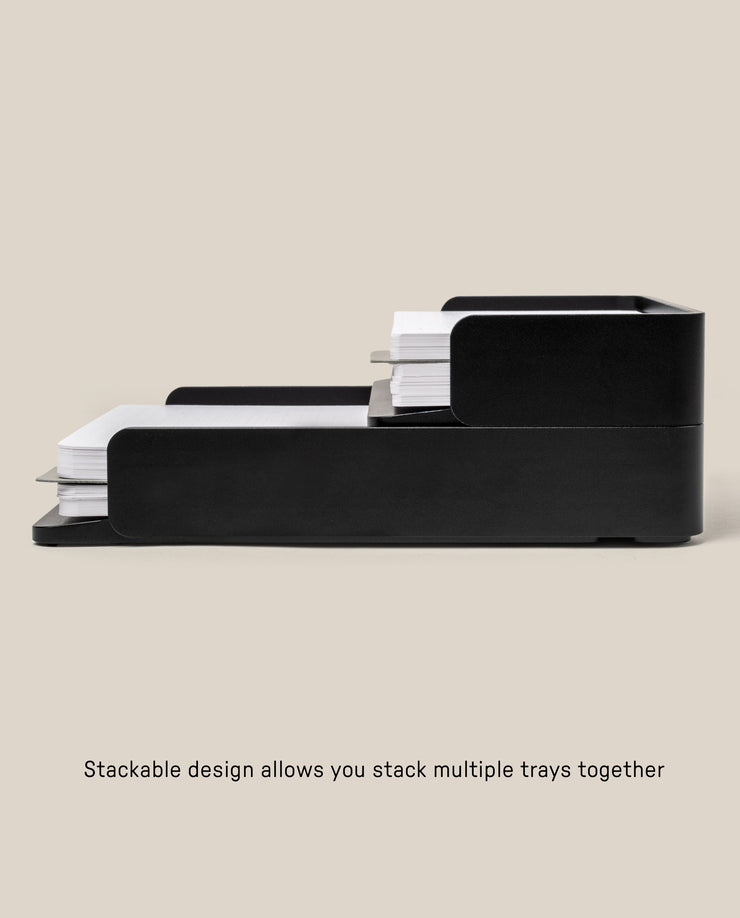 Two black aluminum Analog Capture Kit trays (Small & Large) are stacked, each holding paper or Dot Grid Cards. Their modern, minimalist design features a stackable system for combining multiple trays. Text: Stackable design lets you stack multiple trays together.