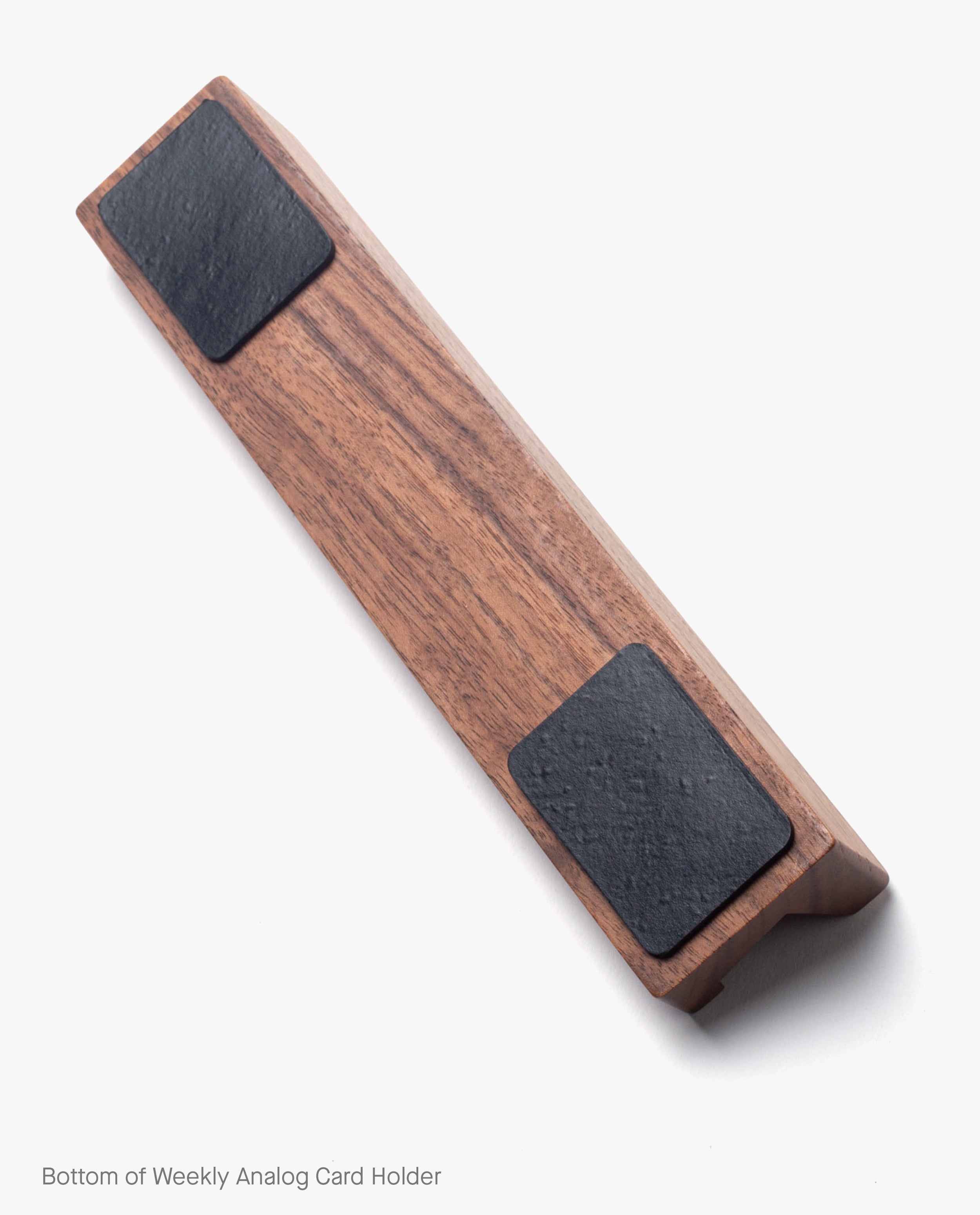 Magnet Kit (Pen Tray and Analog Weekly) featuring a wooden card holder with two black rectangular pads and discreet magnets on the bottom, set against a white background. Text in the image reads: “Bottom of Weekly Analog Card Holder.”.