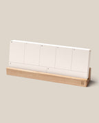 The Analog Weekly Planning Kit (Maple) features white planner cards labeled for each day, neatly arranged in a light maple holder, perfect for minimalist weekly organization.
