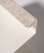 A close-up of the Gather Laptop Stand (White/Maple) shows its rounded edge and beige felt strip, blending minimalist style with ergonomic function. Made in the USA, its neutral look is perfect for any workspace.