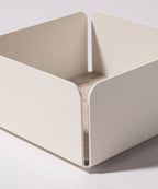 The Gather Small Tray (1x1 - White) is a minimalist, white square tray with rounded corners and a felt-lined base, ideal as a desk organizer. Made in Pennsylvania, it sits perfectly on any light surface.