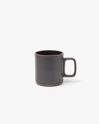 The Hasami Porcelain Mug (Matte Black) features a plain, modern design with a large handle and slightly rounded rim, shown here on a white background.