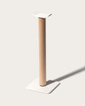 The Gather Headphone Stand (1x1 - White/Maple) features a tall maple wood post, a square white base, and a curved white top platform, all set against a simple light background for a minimalist look.