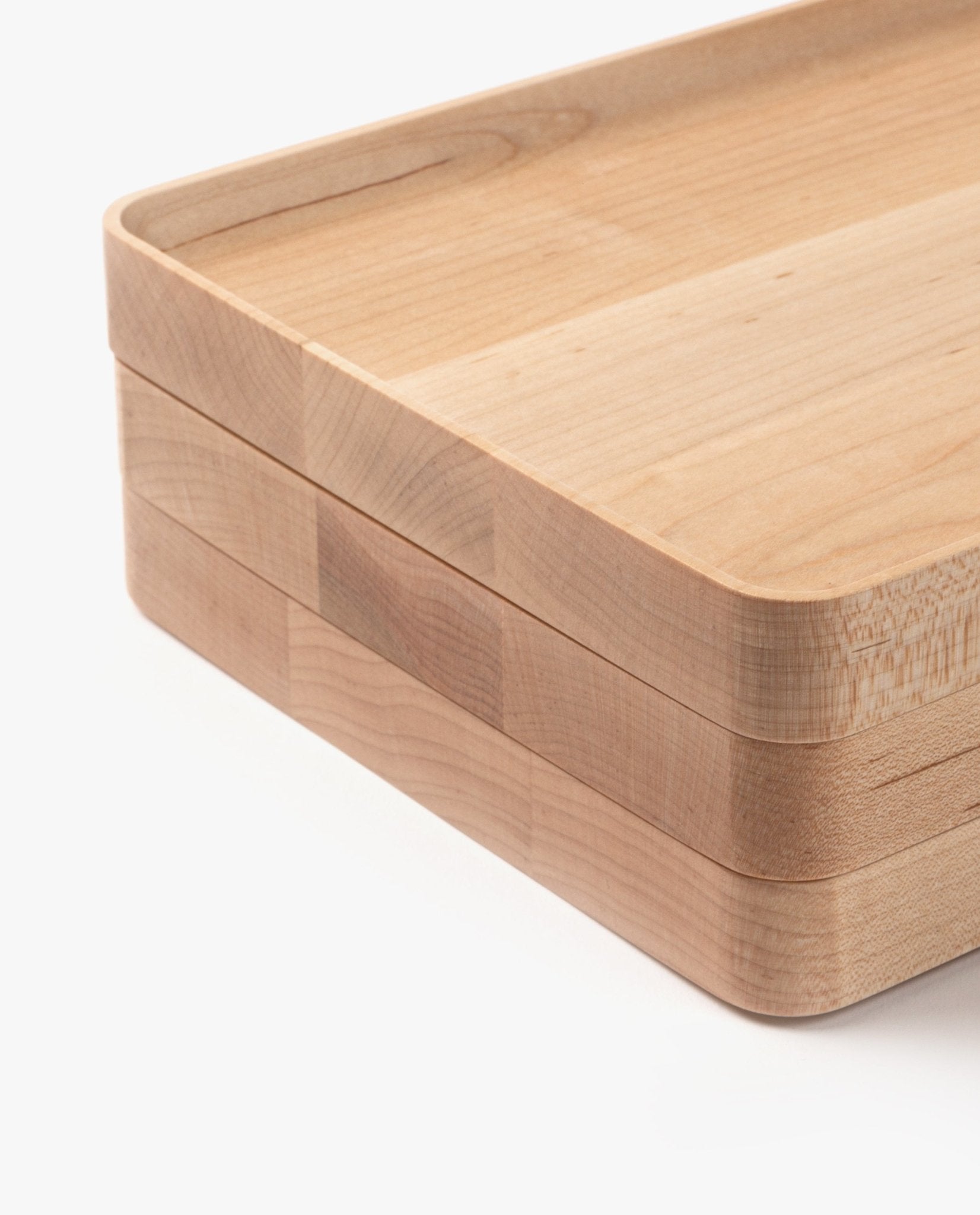 A close-up of the Valet Tray Bundle (Maple - Set of 3), each handcrafted in Pennsylvania with rounded corners, smooth edges, and natural light maple grain, stacked on a white background.
